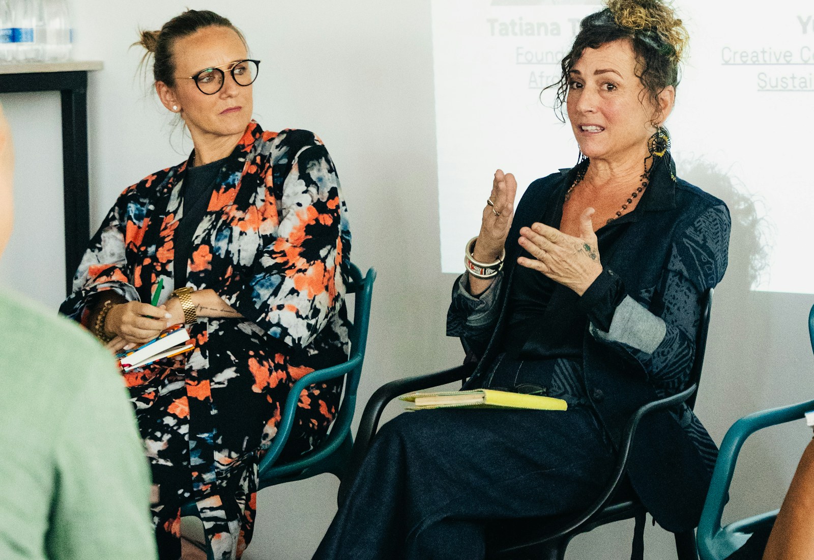 Professional conference speakers presenting on stage.