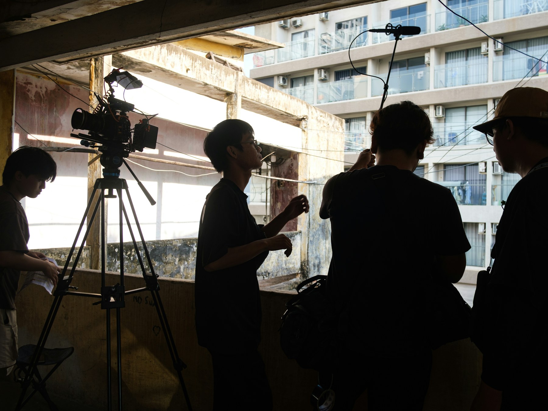 A film crew coordinating camera, lighting, and sound on location.