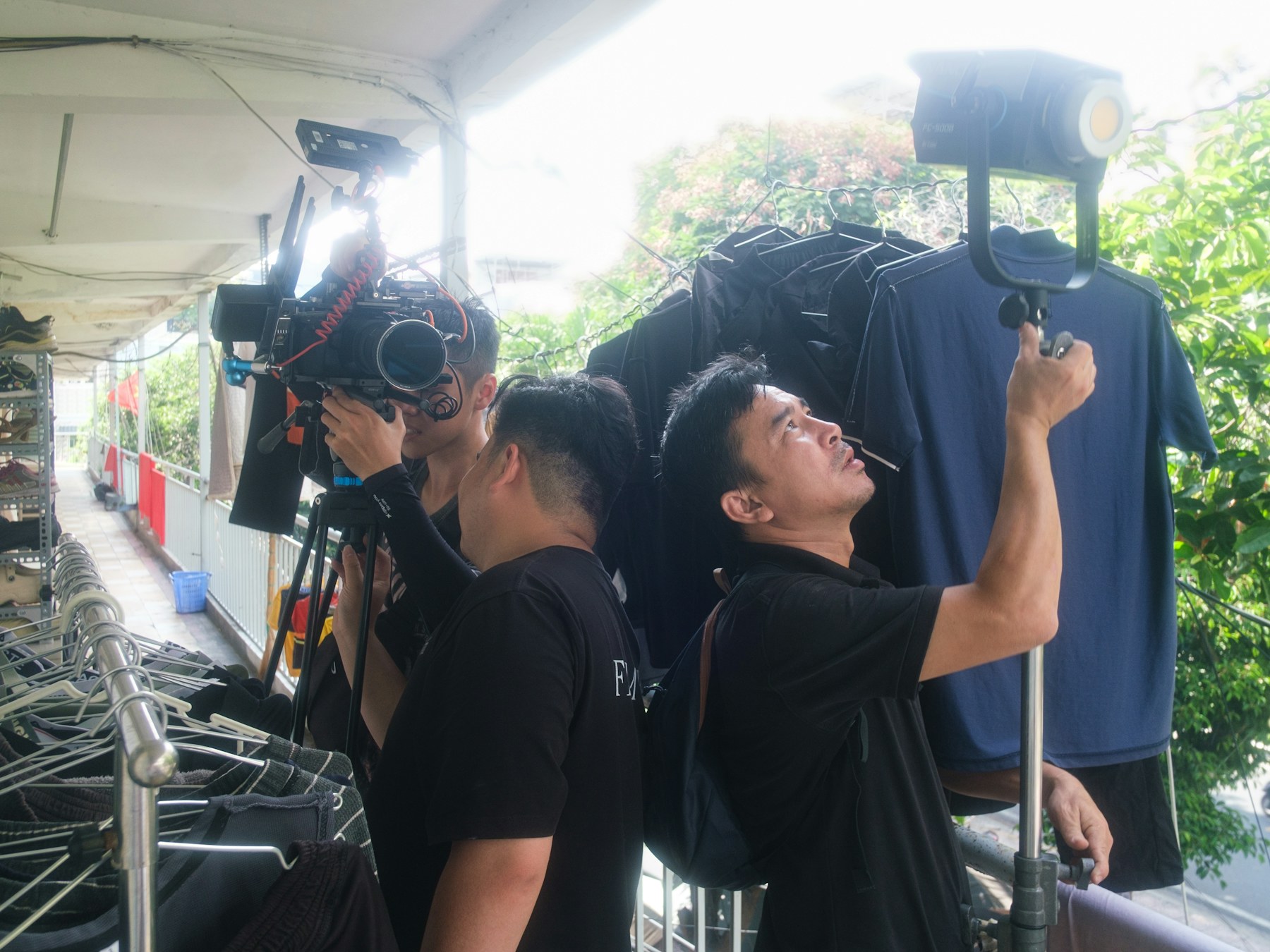 A camera and lighting team filming an interview on location.